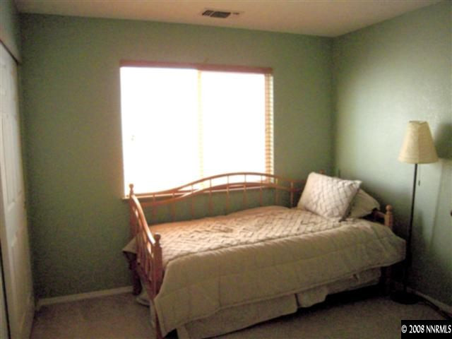 9788 Thunder Mountain Way Reno, NV 89521 - Photo 5 of 5 a bedroom with a bed and a window