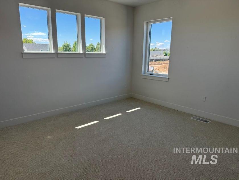 755 West Wrangler Street Meridian, ID 83646 - Photo 25 of 35 Wall-to-wall carpeting with white baseboards, multiple windows, and neutral wall tones