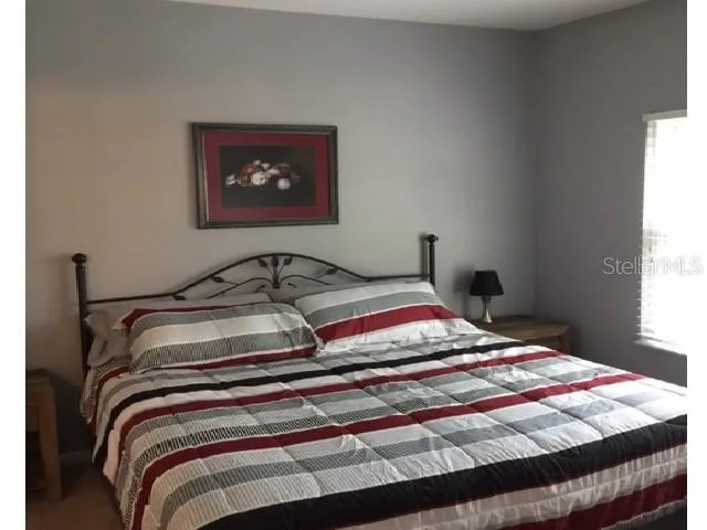 a bedroom with a bed and a window