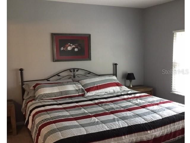 10764 70th Avenue, Unit 1102 Seminole, FL 33772 - Photo 12 of 25 a bedroom with a bed and a window