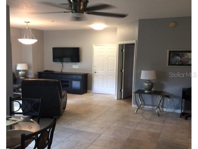 10764 70th Avenue, Unit 1102 Seminole, FL 33772 - Photo 15 of 25 a living room with furniture and a flat screen tv