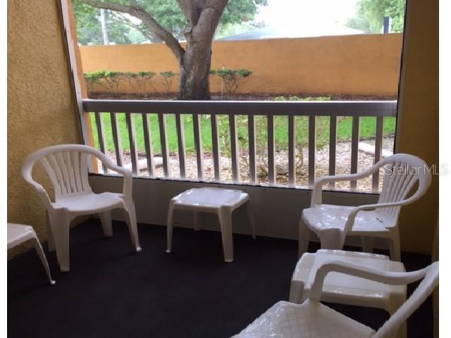 10764 70th Avenue, Unit 1102 Seminole, FL 33772 - Photo 4 of 25 a view of a chair and table in the balcony