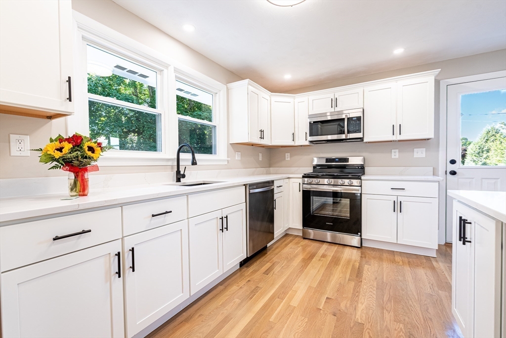 17 Hamlet Street Fairhaven, MA 02719 - Photo 12 of 40 a kitchen with white cabinets a window and a sink
