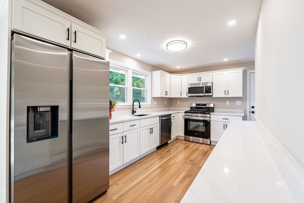 17 Hamlet Street Fairhaven, MA 02719 - Photo 14 of 40 a kitchen with a refrigerator a sink and cabinets