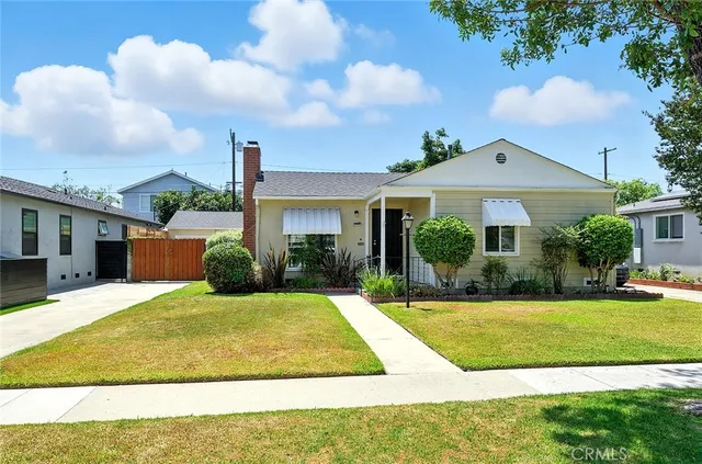 a view of a white house with a swimming pool and a yard