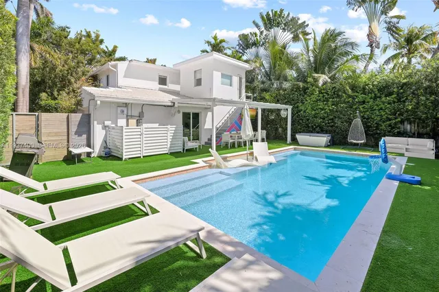 a view of a house with a yard porch and sitting area