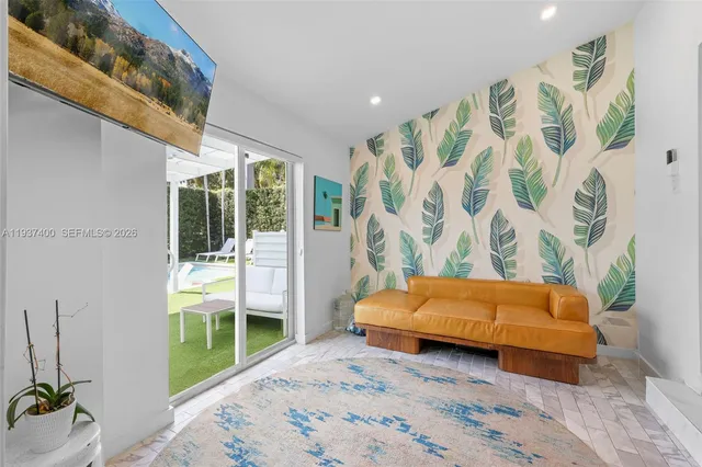 a room with a couch and a potted plant