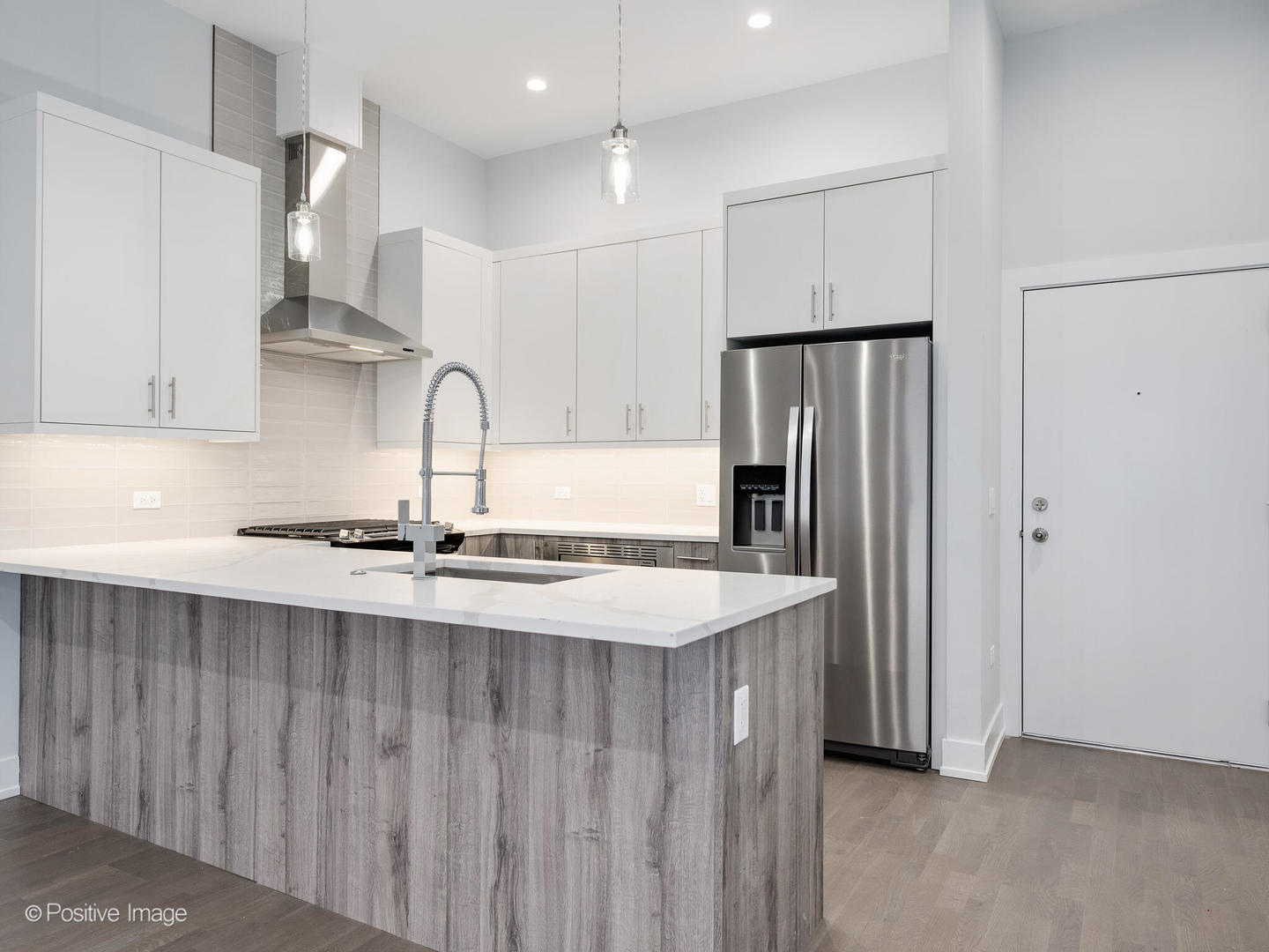 2139 West Madison Street, Unit 201 Chicago, IL 60612 - Photo 3 of 11 a kitchen with stainless steel appliances granite countertop a refrigerator and a sink
