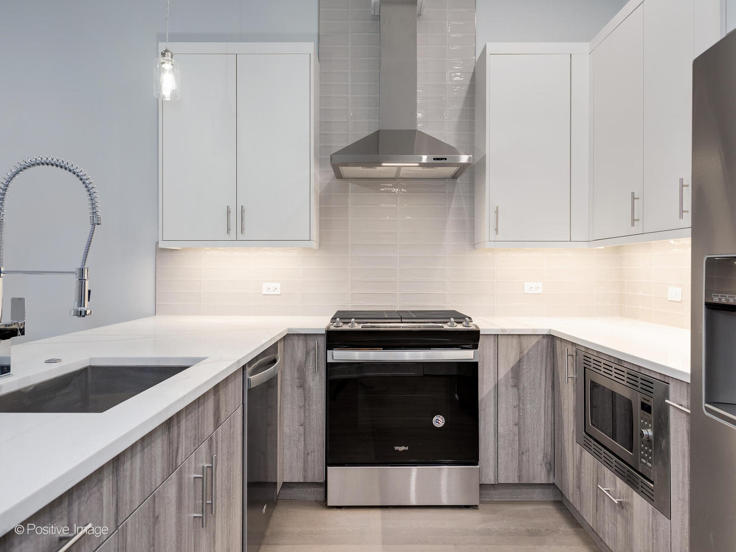 2139 West Madison Street, Unit 201 Chicago, IL 60612 - Photo 4 of 11 a kitchen with a sink stove and cabinets