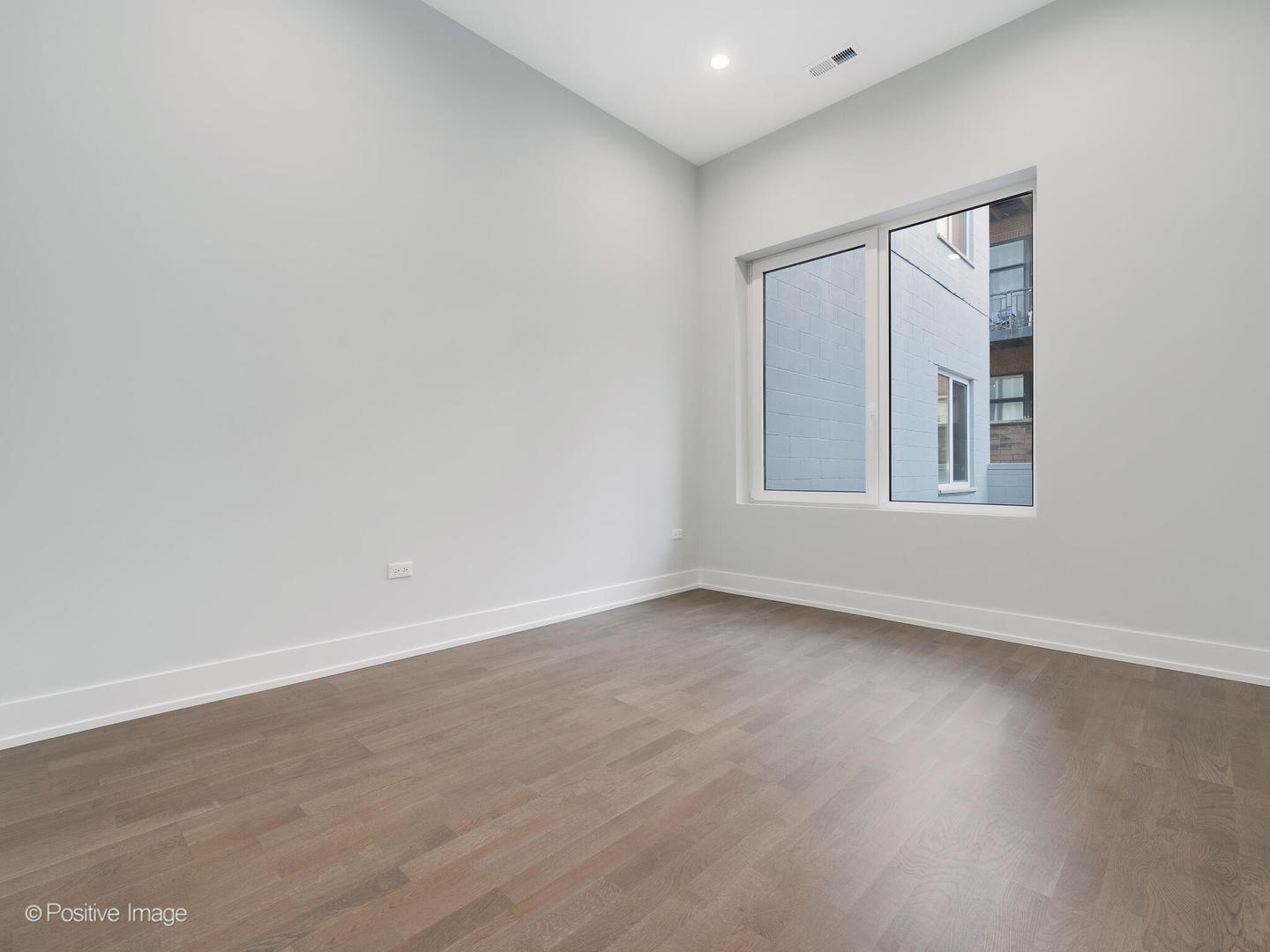 2139 West Madison Street, Unit 201 Chicago, IL 60612 - Photo 8 of 11 a view of an empty room with wooden floor and a window