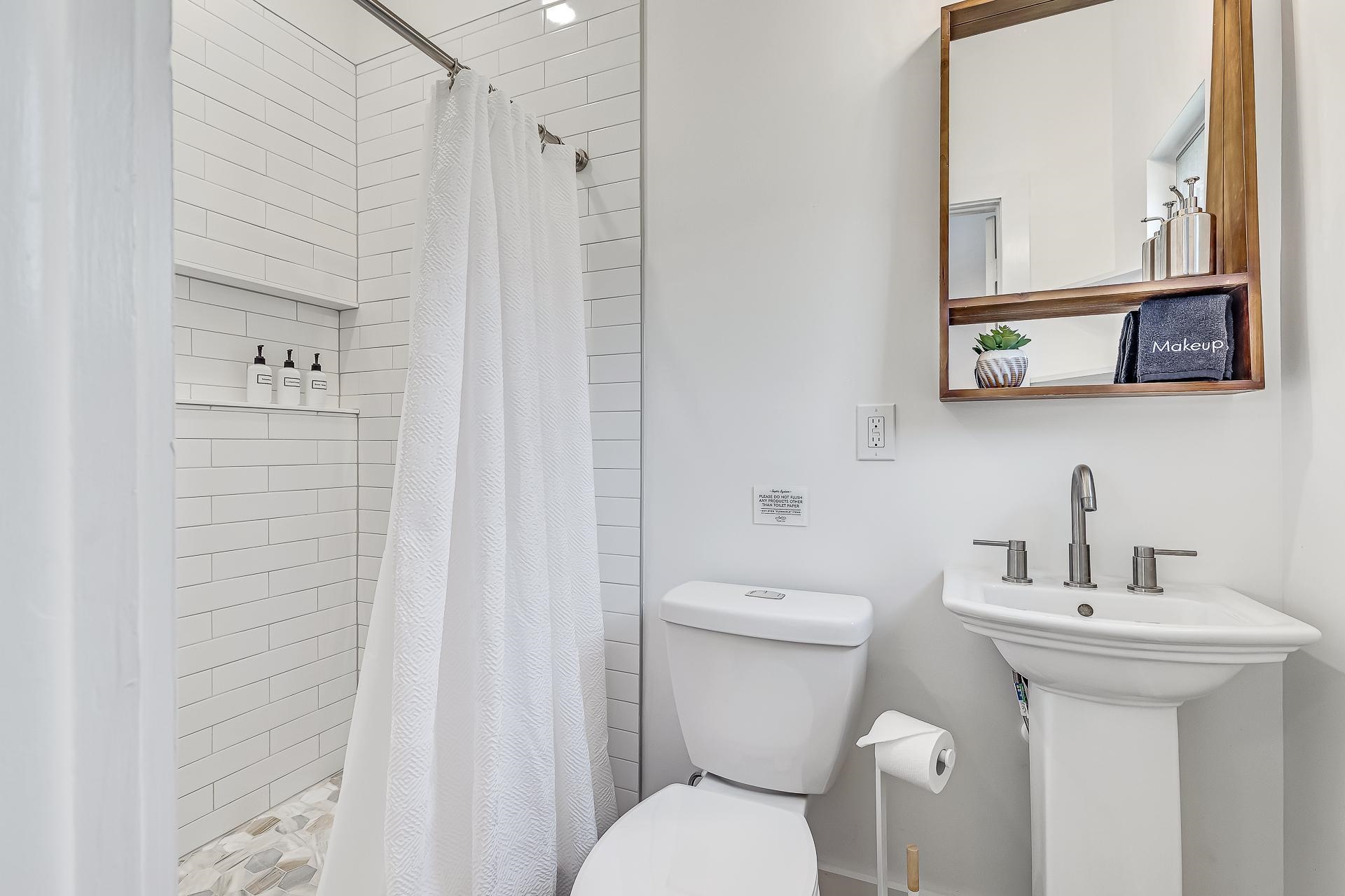 110 Terrapin Road St. Augustine, FL 32086 - Photo 16 of 46 a bathroom with a toilet sink and mirror