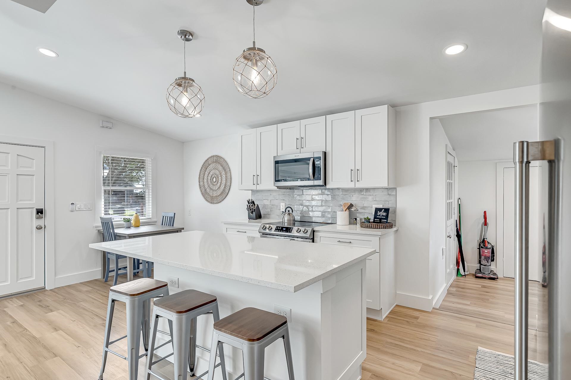 110 Terrapin Road St. Augustine, FL 32086 - Photo 6 of 46 a kitchen with stainless steel appliances granite countertop a sink a stove a refrigerator cabinets and chairs