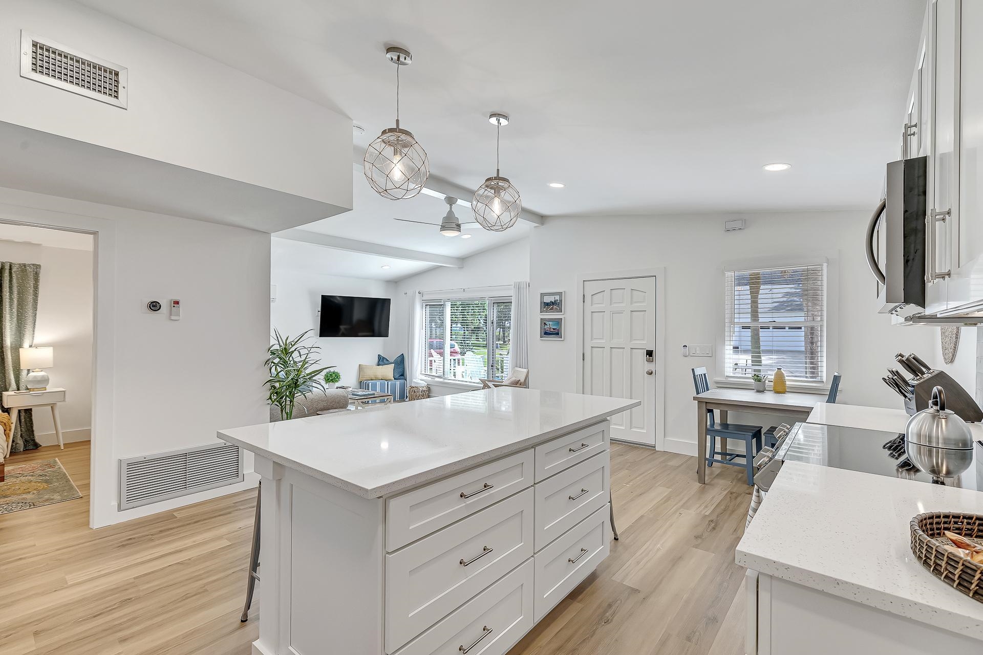 110 Terrapin Road St. Augustine, FL 32086 - Photo 7 of 46 a view of living room kitchen island stainless steel appliances and wooden floor