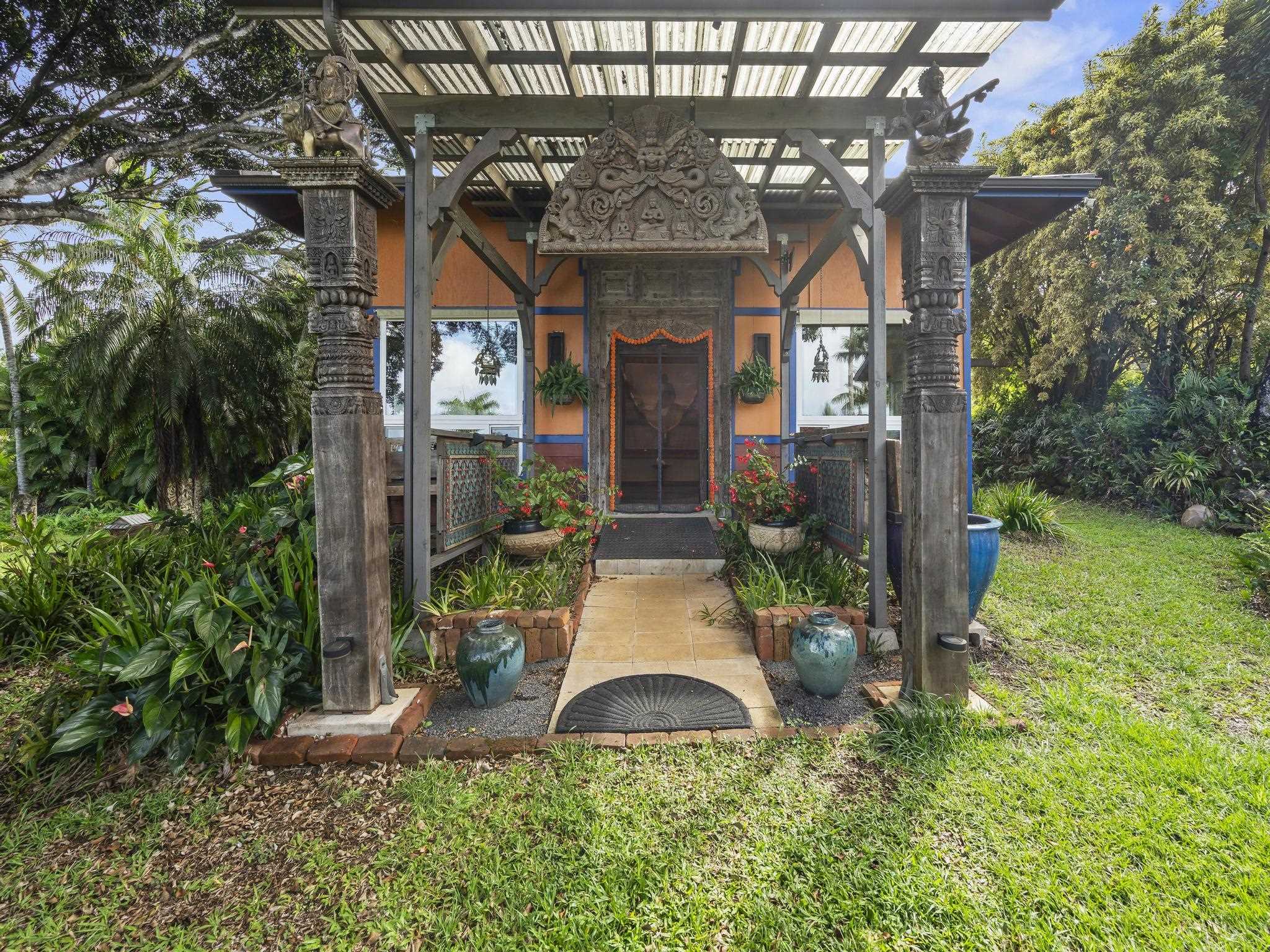 245 North Honokala Road, Unit A Haiku, HI 96708 - Photo 12 of 36 front view of a house with a small yard and potted plants