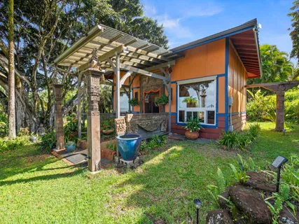 a view of a house with backyard porch and sitting area