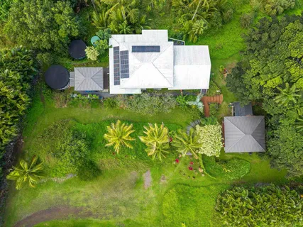 an aerial view of a house with pool yard and outdoor seating