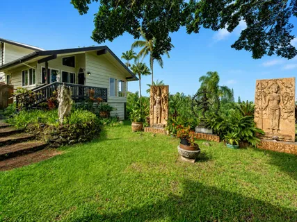 a front view of a house with a garden