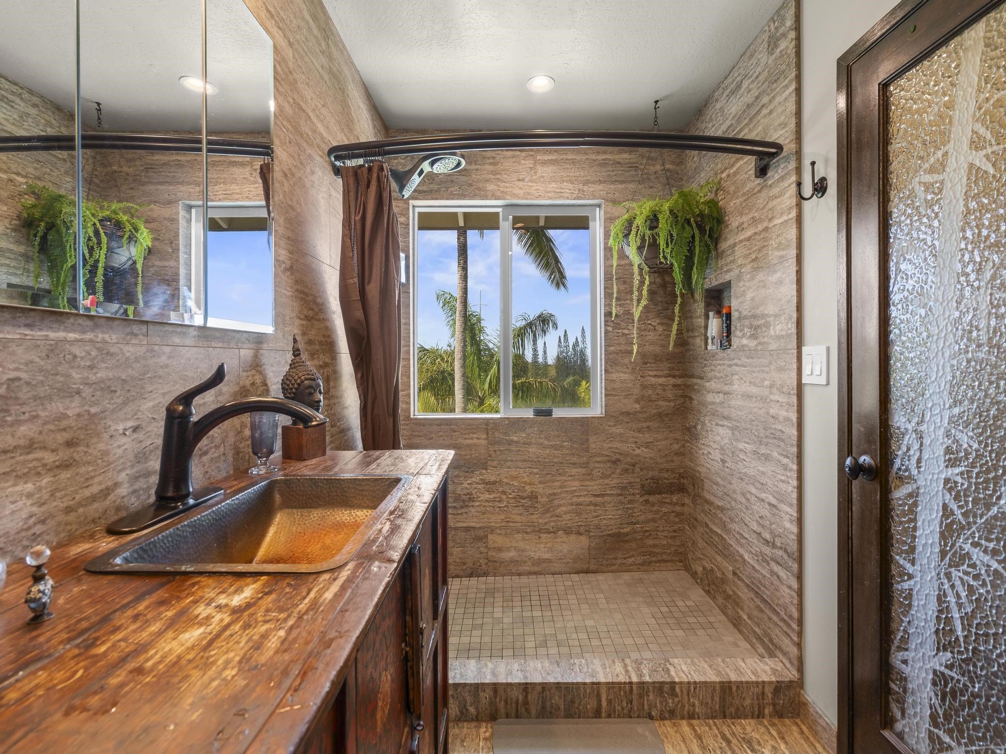 245 North Honokala Road, Unit A Haiku, HI 96708 - Photo 7 of 36 a bathroom with a granite countertop sink a mirror and shower