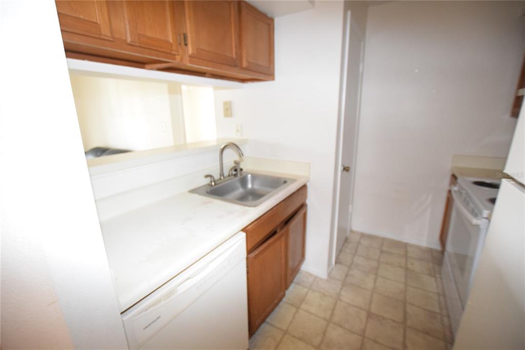 4659 Cason Cove Drive, Unit 3022 Orlando, FL 32811 - Photo 15 of 29 a kitchen with a sink and cabinets
