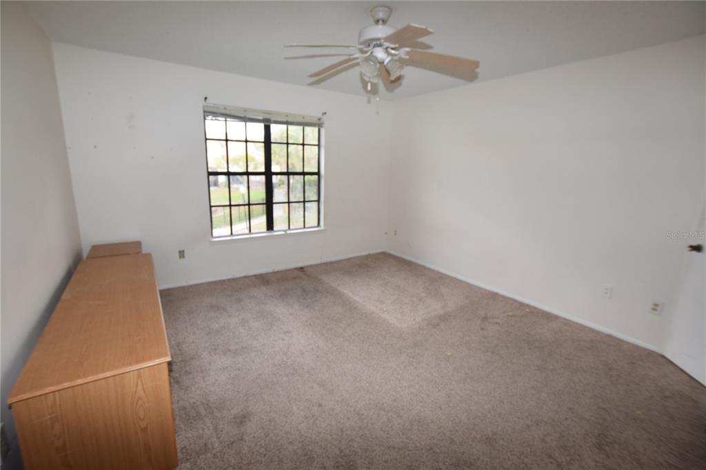 4659 Cason Cove Drive, Unit 3022 Orlando, FL 32811 - Photo 19 of 29 an empty room with windows and fan