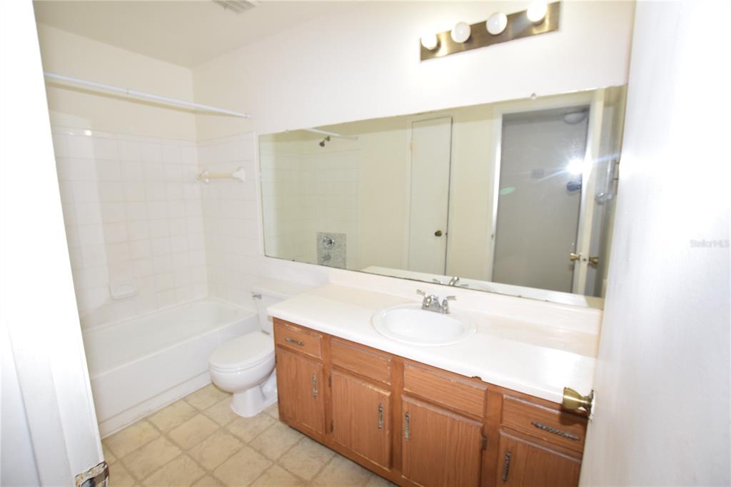 4659 Cason Cove Drive, Unit 3022 Orlando, FL 32811 - Photo 23 of 29 a bathroom with a sink a toilet and shower