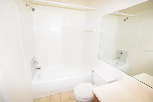 a view of a hallway with wooden floor and stairs