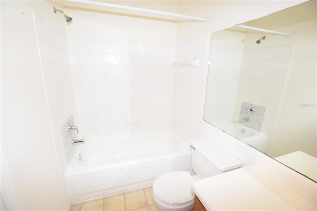 4659 Cason Cove Drive, Unit 3022 Orlando, FL 32811 - Photo 24 of 29 a bathroom with a toilet and a bathtub