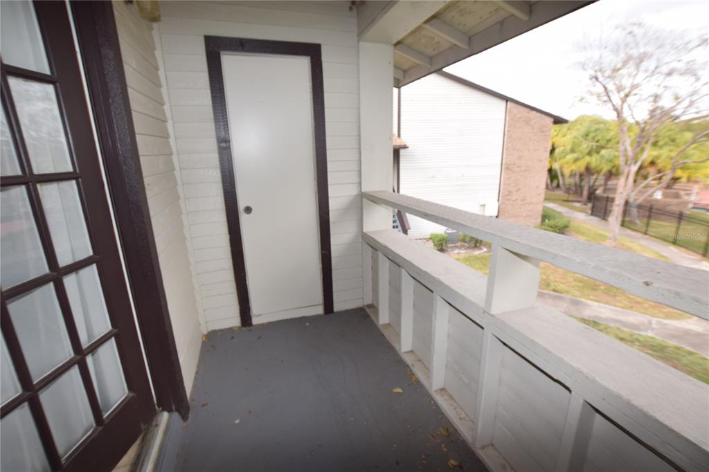 4659 Cason Cove Drive, Unit 3022 Orlando, FL 32811 - Photo 27 of 29 a view of a hallway with wooden floor and stairs