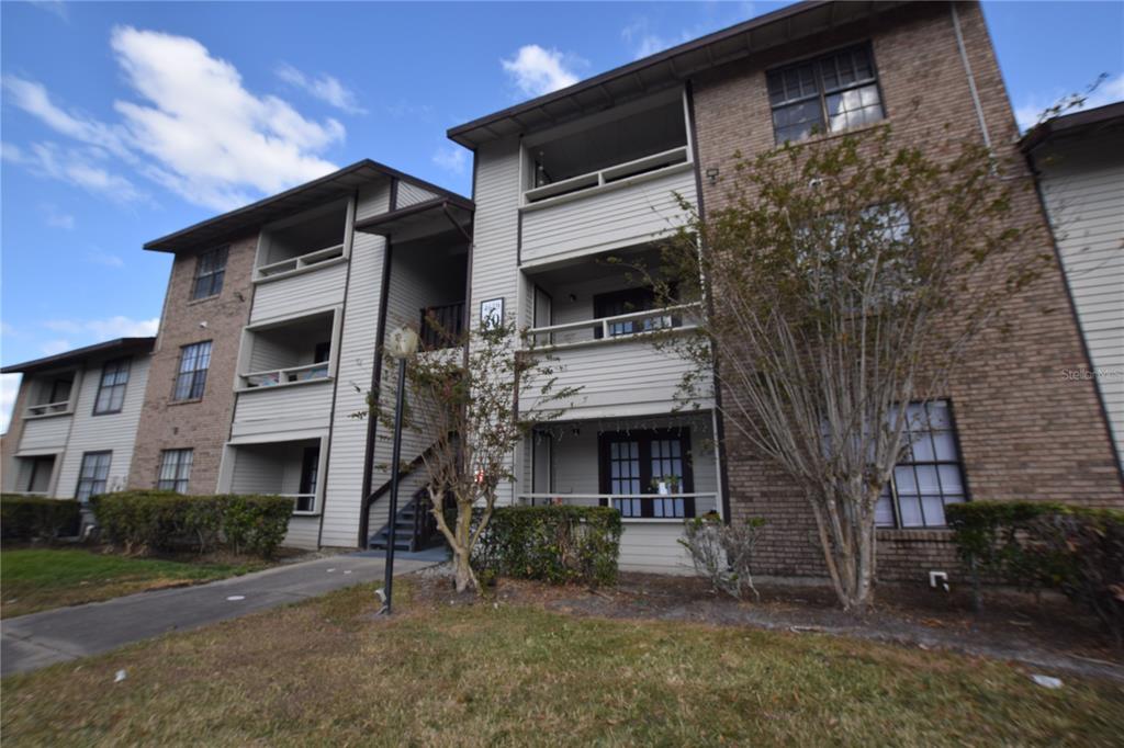 4659 Cason Cove Drive, Unit 3022 Orlando, FL 32811 - Photo 4 of 29 a view of a house with a yard