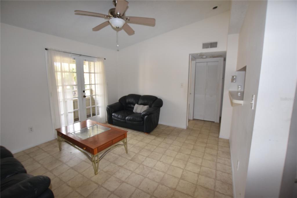 4659 Cason Cove Drive, Unit 3022 Orlando, FL 32811 - Photo 7 of 29 a living room with furniture and a window