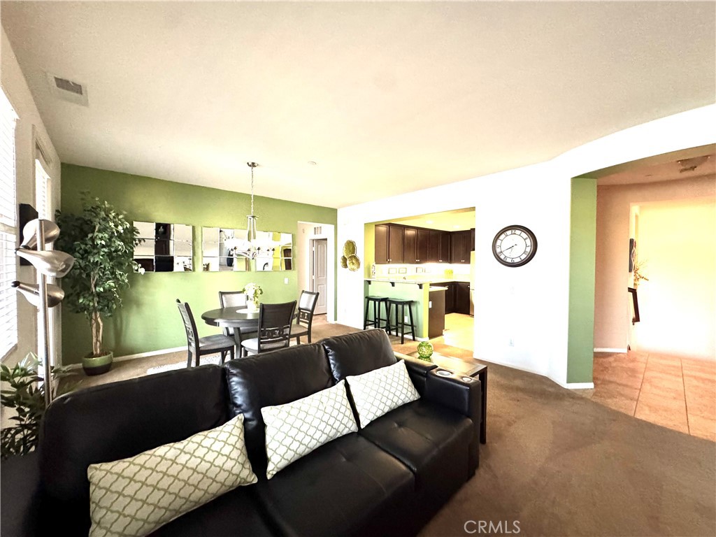 7666 Papyrus Place, Unit 2 Rancho Cucamonga, CA 91739 - Photo 13 of 23 a living room with furniture and wooden floor