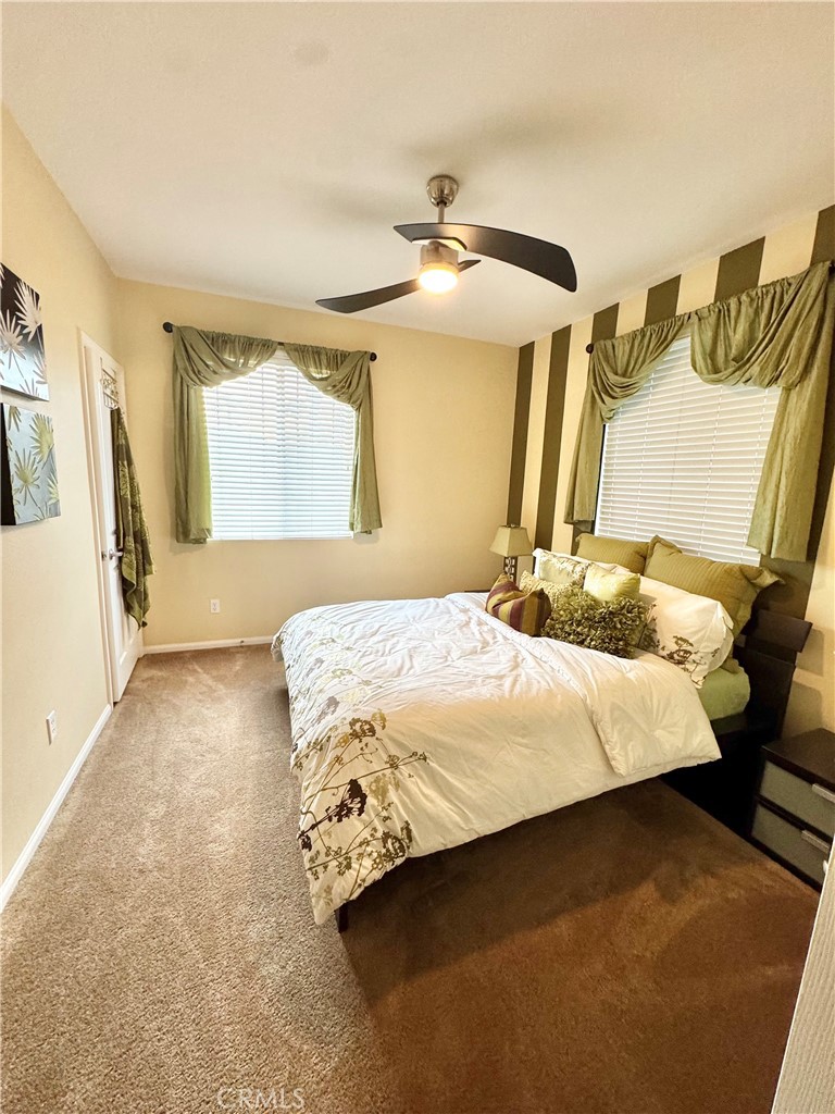 7666 Papyrus Place, Unit 2 Rancho Cucamonga, CA 91739 - Photo 14 of 23 a bedroom with a bed and a walk in closet