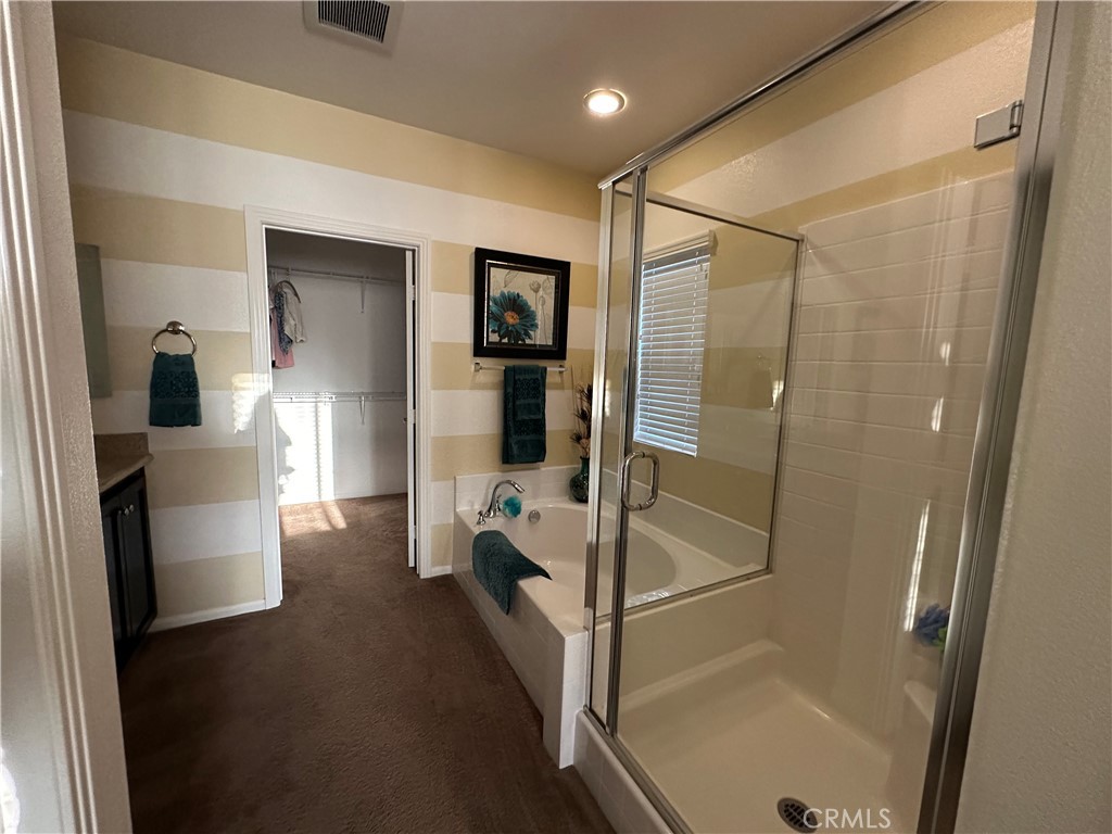 7666 Papyrus Place, Unit 2 Rancho Cucamonga, CA 91739 - Photo 16 of 23 a bathroom with a tub and shower