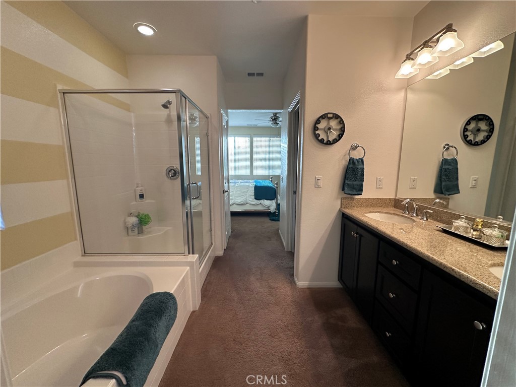 7666 Papyrus Place, Unit 2 Rancho Cucamonga, CA 91739 - Photo 17 of 23 a bathroom with a double vanity sink mirror and shower