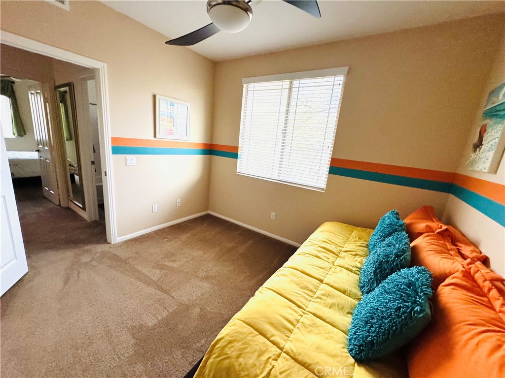 7666 Papyrus Place, Unit 2 Rancho Cucamonga, CA 91739 - Photo 21 of 23 a bed sitting in a bedroom next to a window