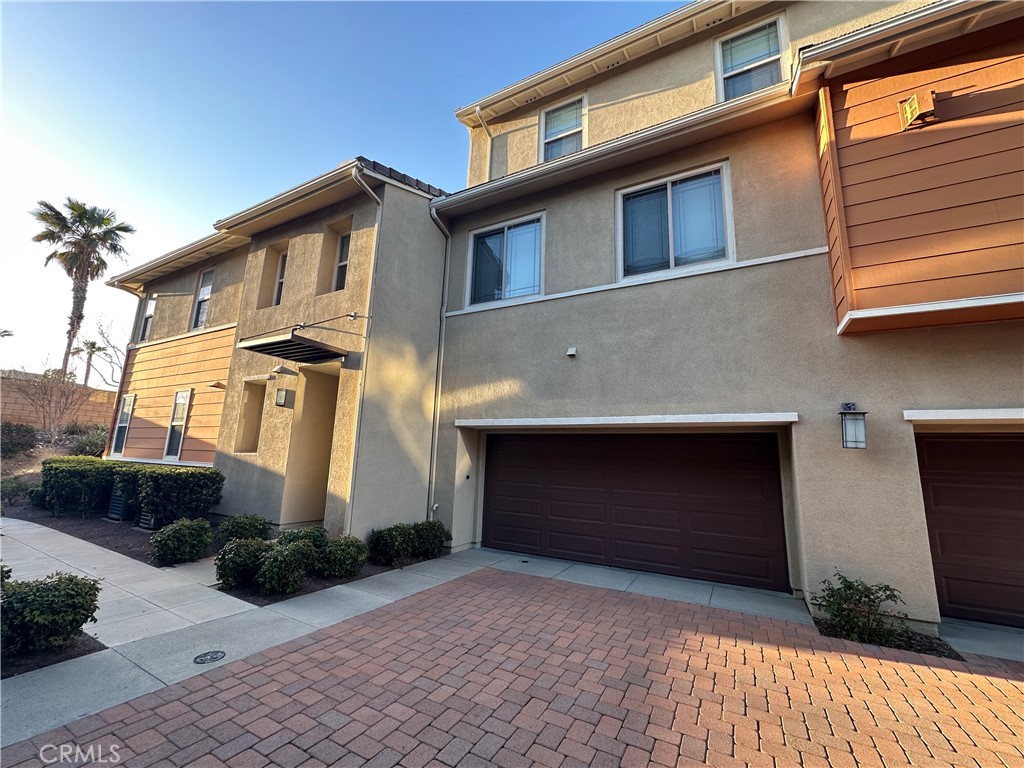 7666 Papyrus Place, Unit 2 Rancho Cucamonga, CA 91739 - Photo 3 of 23 a front view of a house with garden