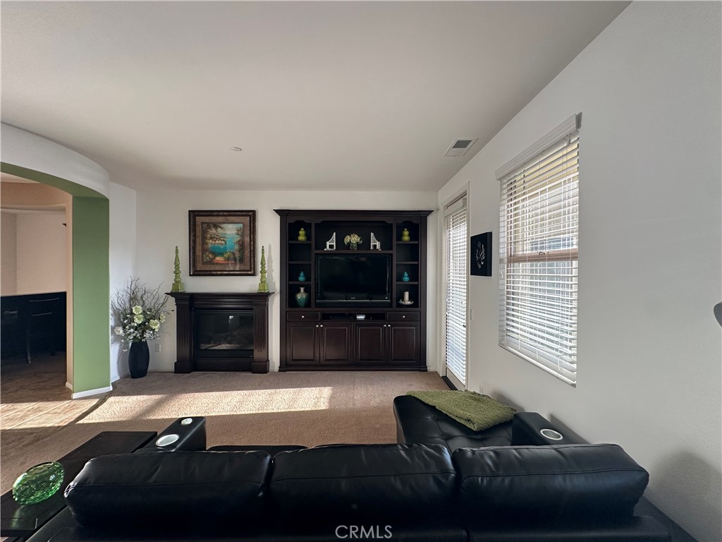 7666 Papyrus Place, Unit 2 Rancho Cucamonga, CA 91739 - Photo 8 of 23 a room with furniture and a flat screen tv