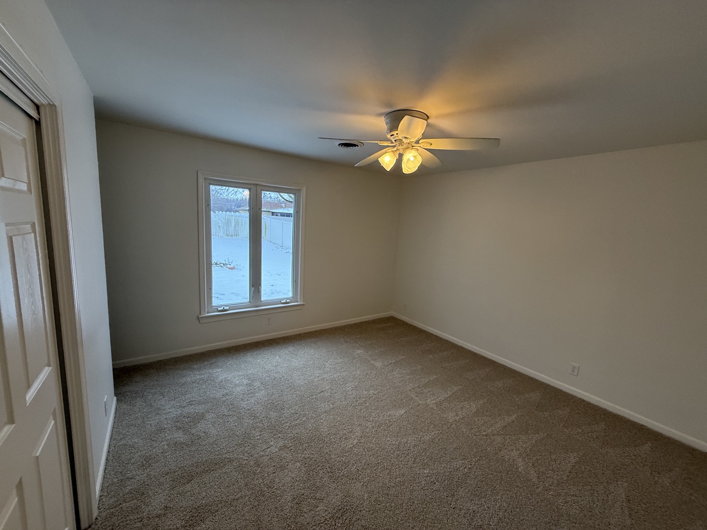 185 Jacqueline Street Morris, IL 60450 - Photo 13 of 19 an empty room with windows and chandelier fan