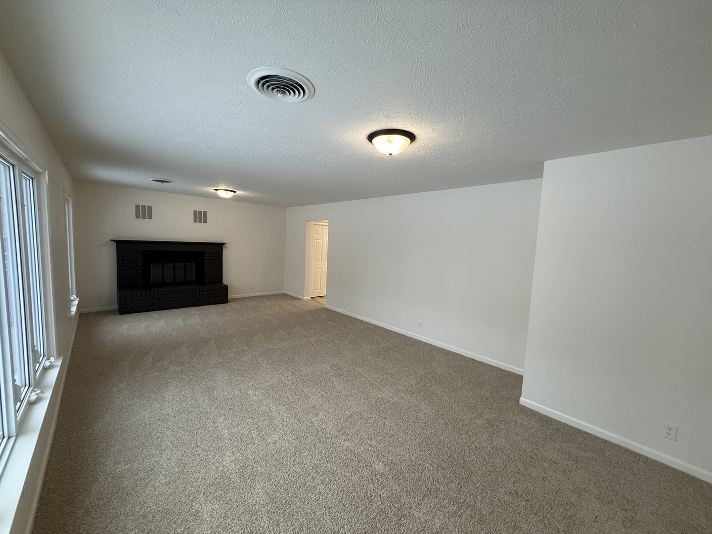 185 Jacqueline Street Morris, IL 60450 - Photo 2 of 19 a view of a livingroom with an empty space and a fireplace