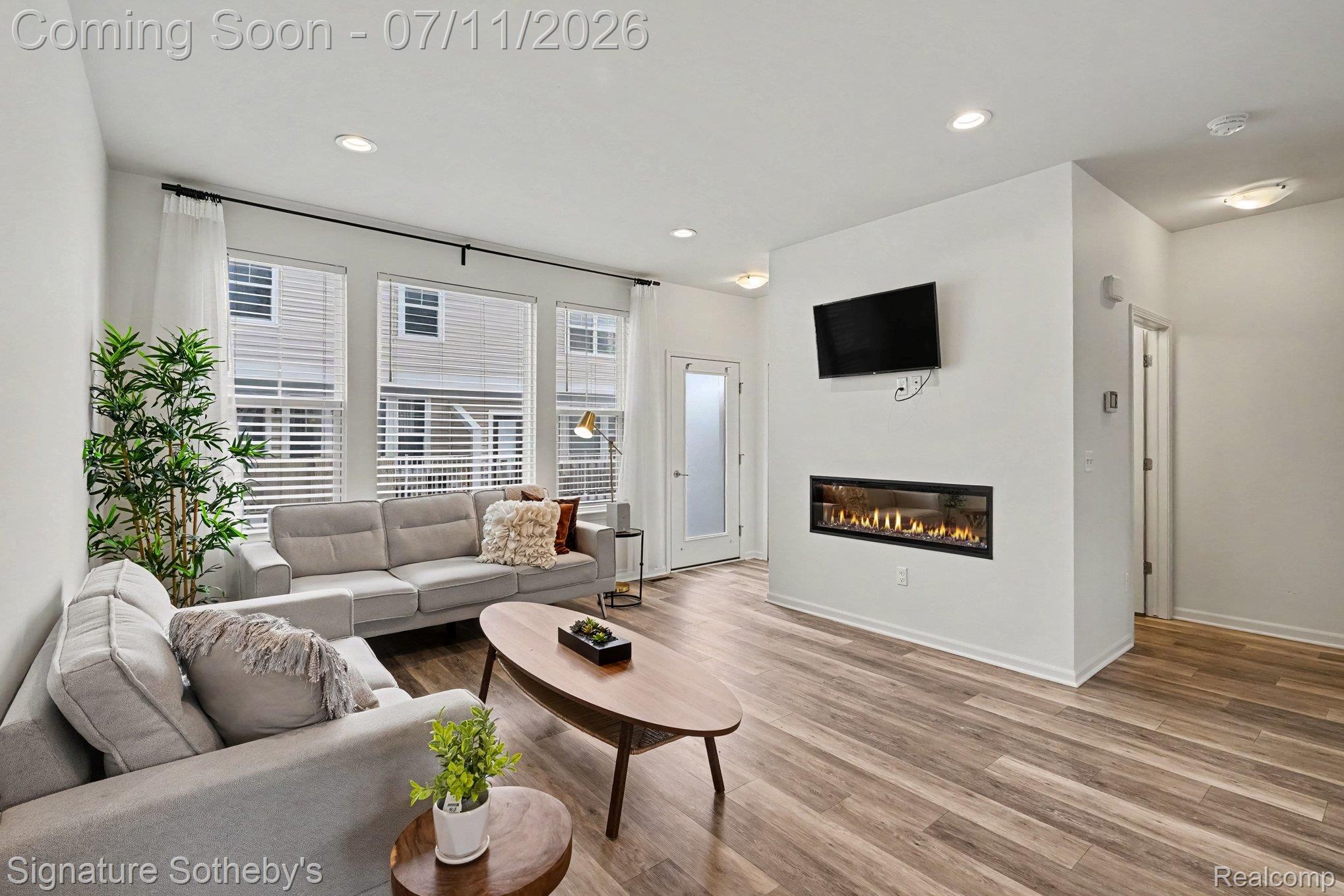 2500 Normandy Road, Unit 40 Royal Oak, MI 48073 - Photo 8 of 26 Living area featuring wood-finish flooring, recessed lighting, and a modern linear fireplace