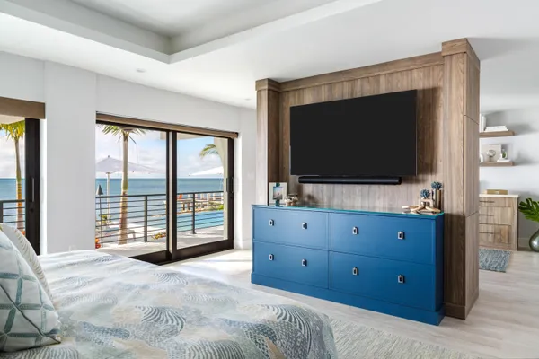 a living room with furniture a flat screen tv and a large window