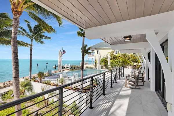 a bedroom with a large bed and a night stand