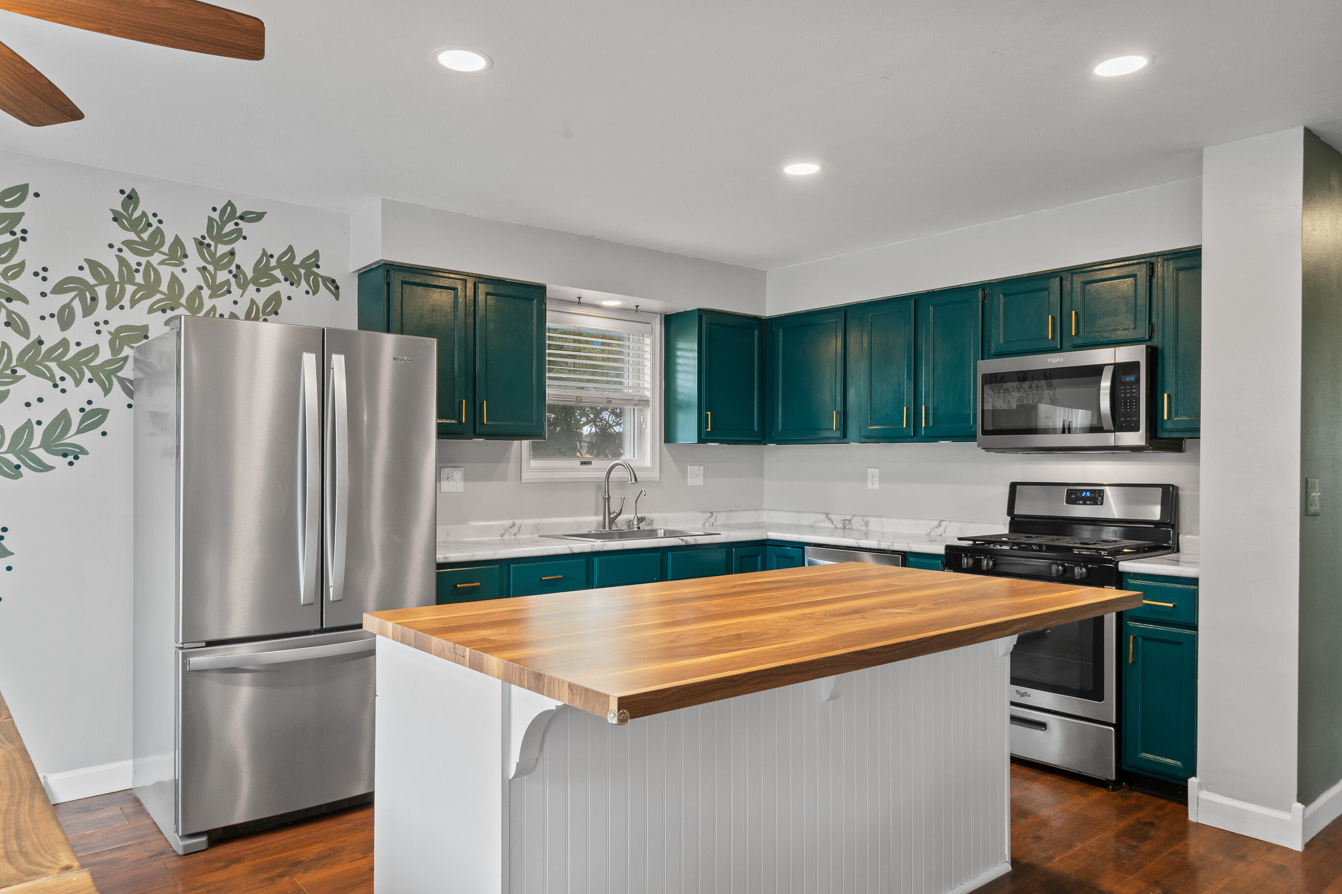 2212 Borg Road Delavan, WI 53115 - Photo 12 of 43 Kitchen featuring teal cabinetry, stainless steel French door refrigerator, over-the-range microwave, gas range, marble-look countertops, and butcher block styled island