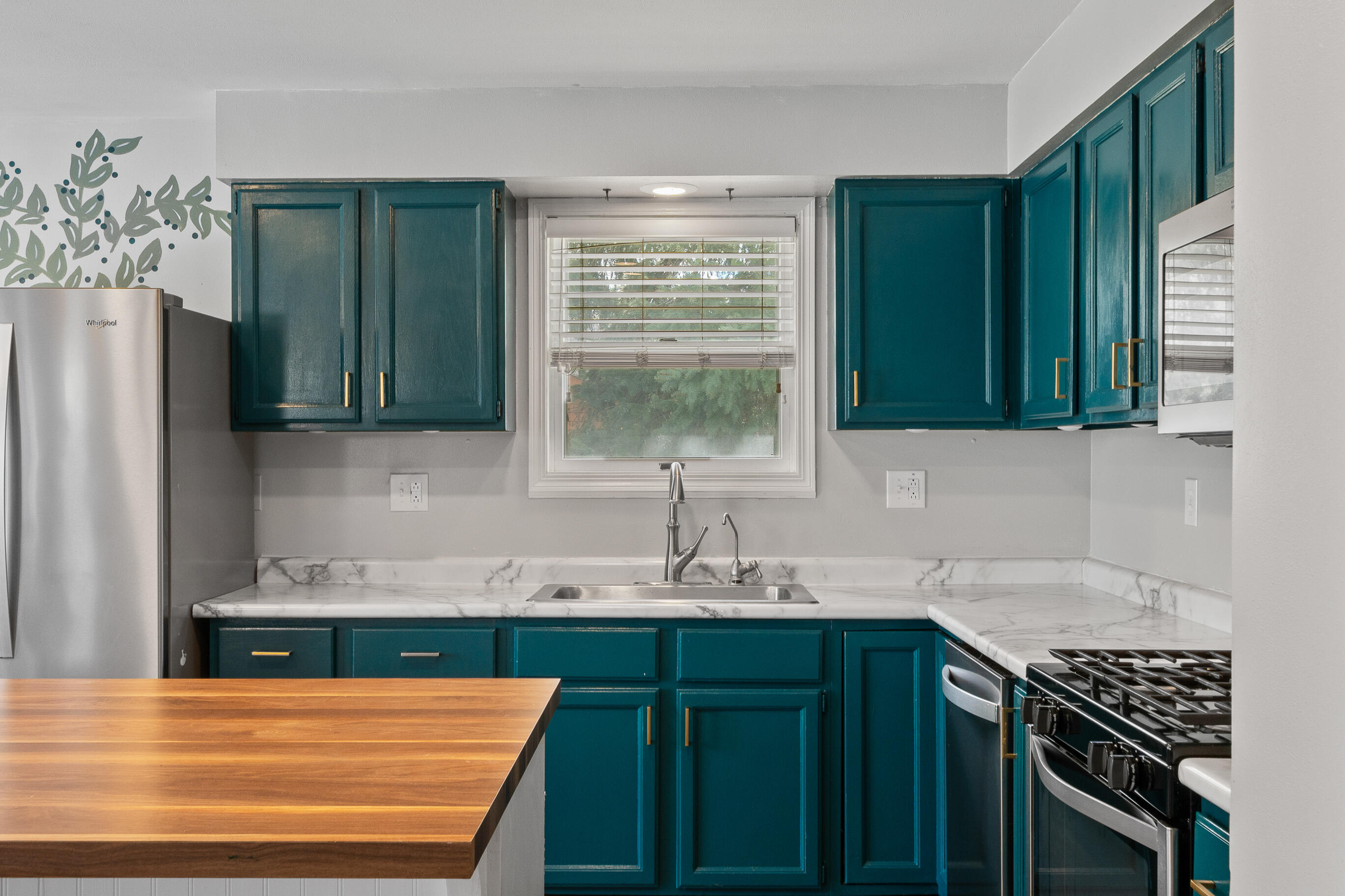 2212 Borg Road Delavan, WI 53115 - Photo 14 of 43 Kitchen with teal painted cabinets, gold hardware, marble-look countertops, stainless steel sink