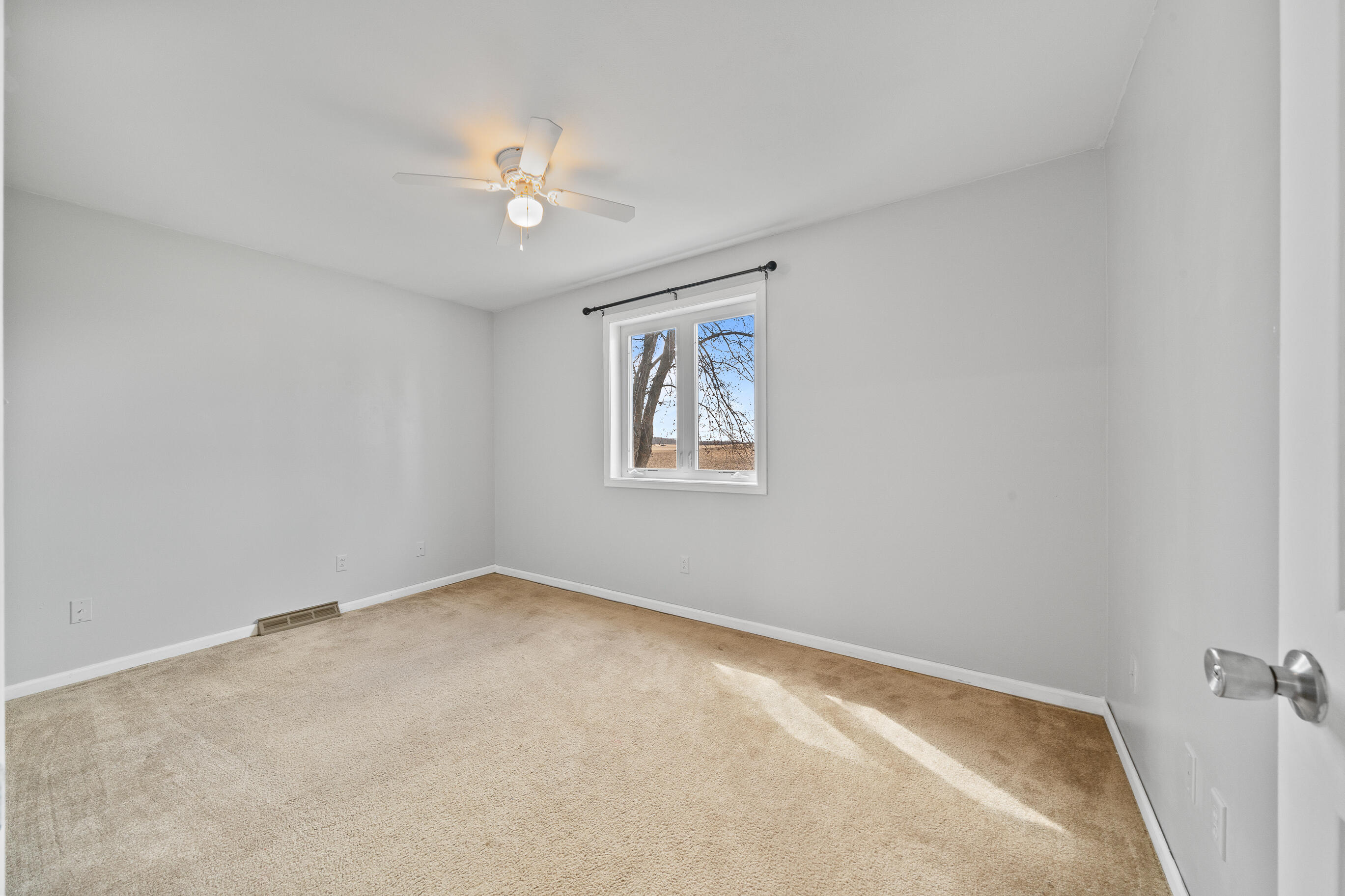 2212 Borg Road Delavan, WI 53115 - Photo 27 of 43 Second bedroom with neutral carpet, ceiling fan, curtain rod, and natural light