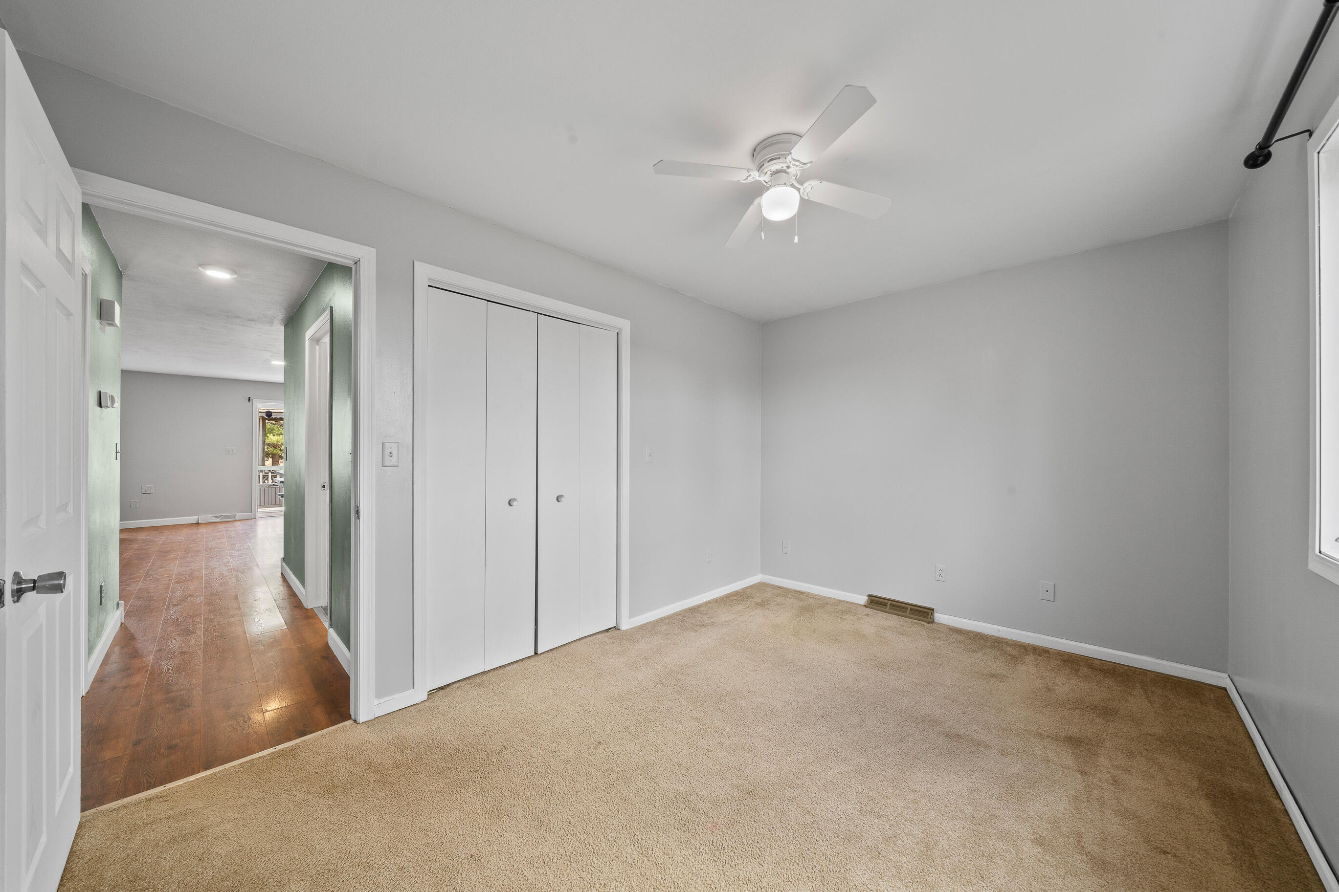 2212 Borg Road Delavan, WI 53115 - Photo 28 of 43 Second bedroom with carpet, ceiling fan, bi-fold closet doors