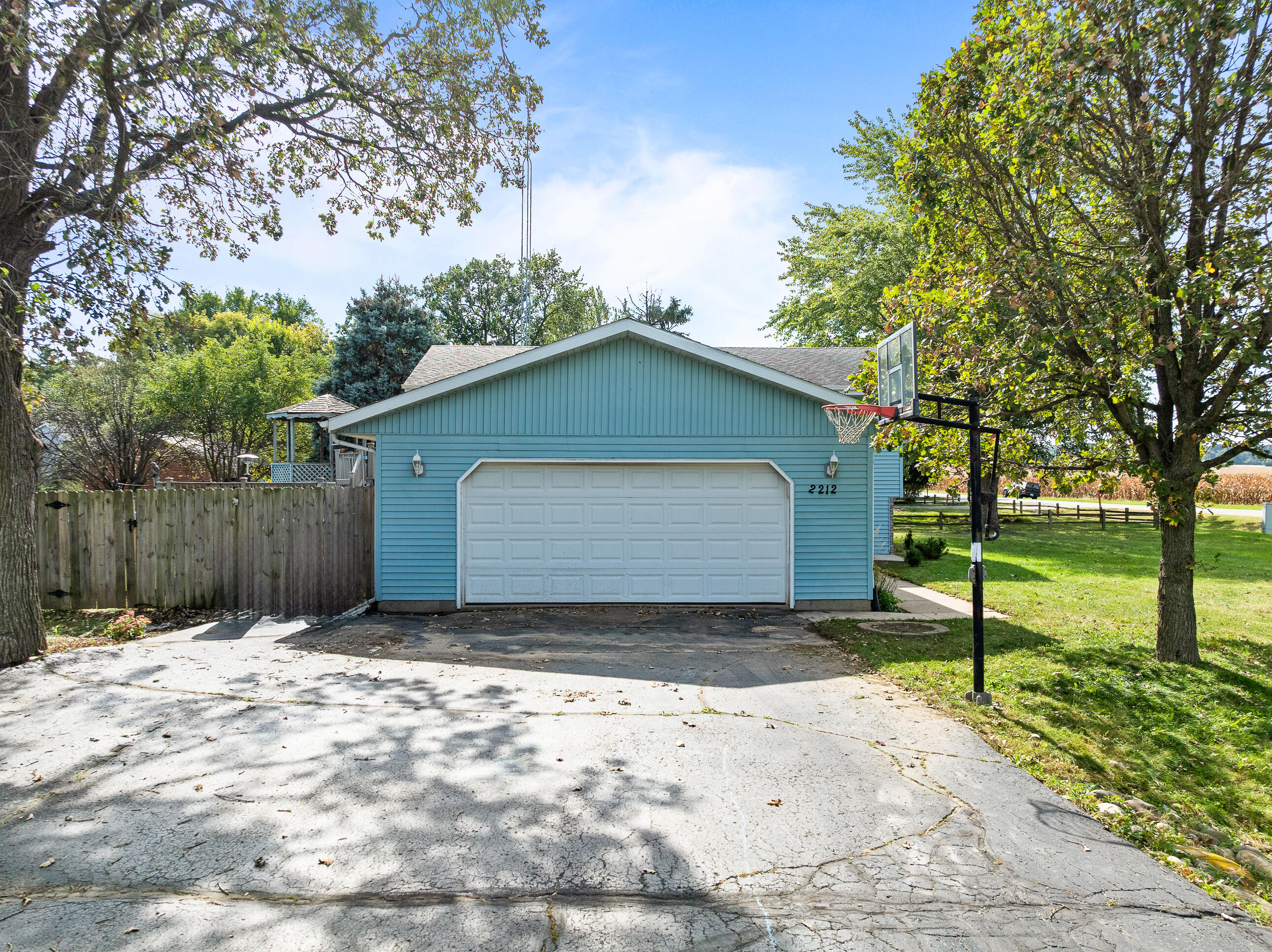 2212 Borg Road Delavan, WI 53115 - Photo 4 of 15 Two-car attached garage with wide asphalt driveway providing ample off-street parking. Basketball hoop included!