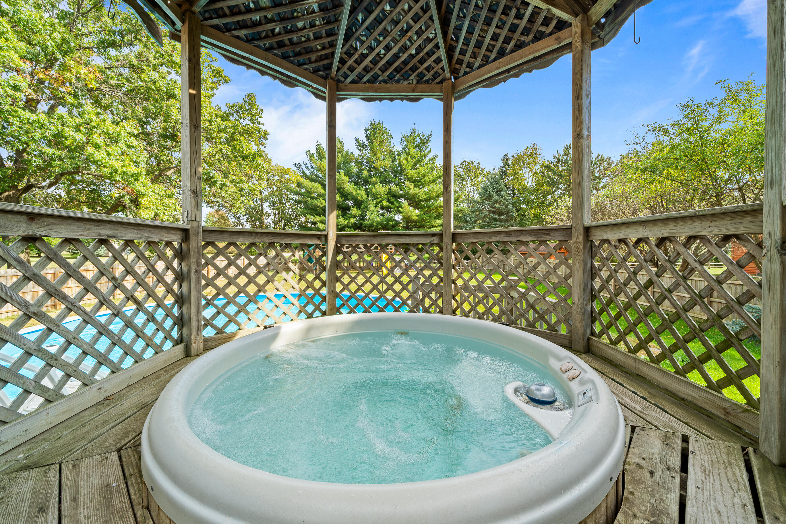 2212 Borg Road Delavan, WI 53115 - Photo 10 of 15 Year-round enjoyment in the private gazebo hot tub. Octagonal wood construction with shingled roof and views of the pool and backyard.