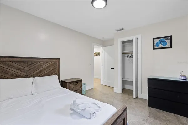 a bedroom with a bed and cabinets