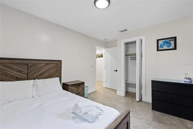 a bedroom with a bed and cabinets